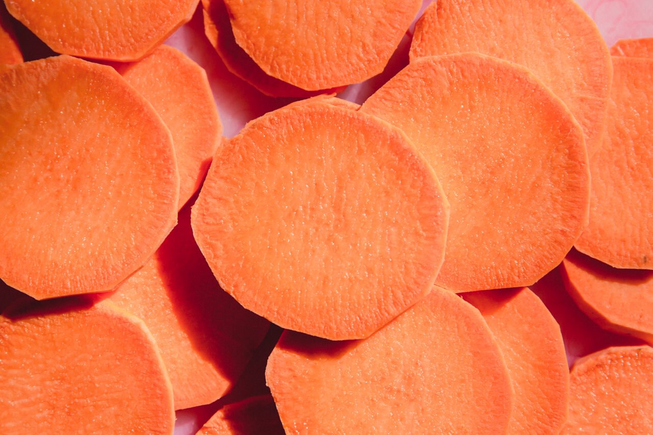 Sliced sweet potato rounds on a cutting board.