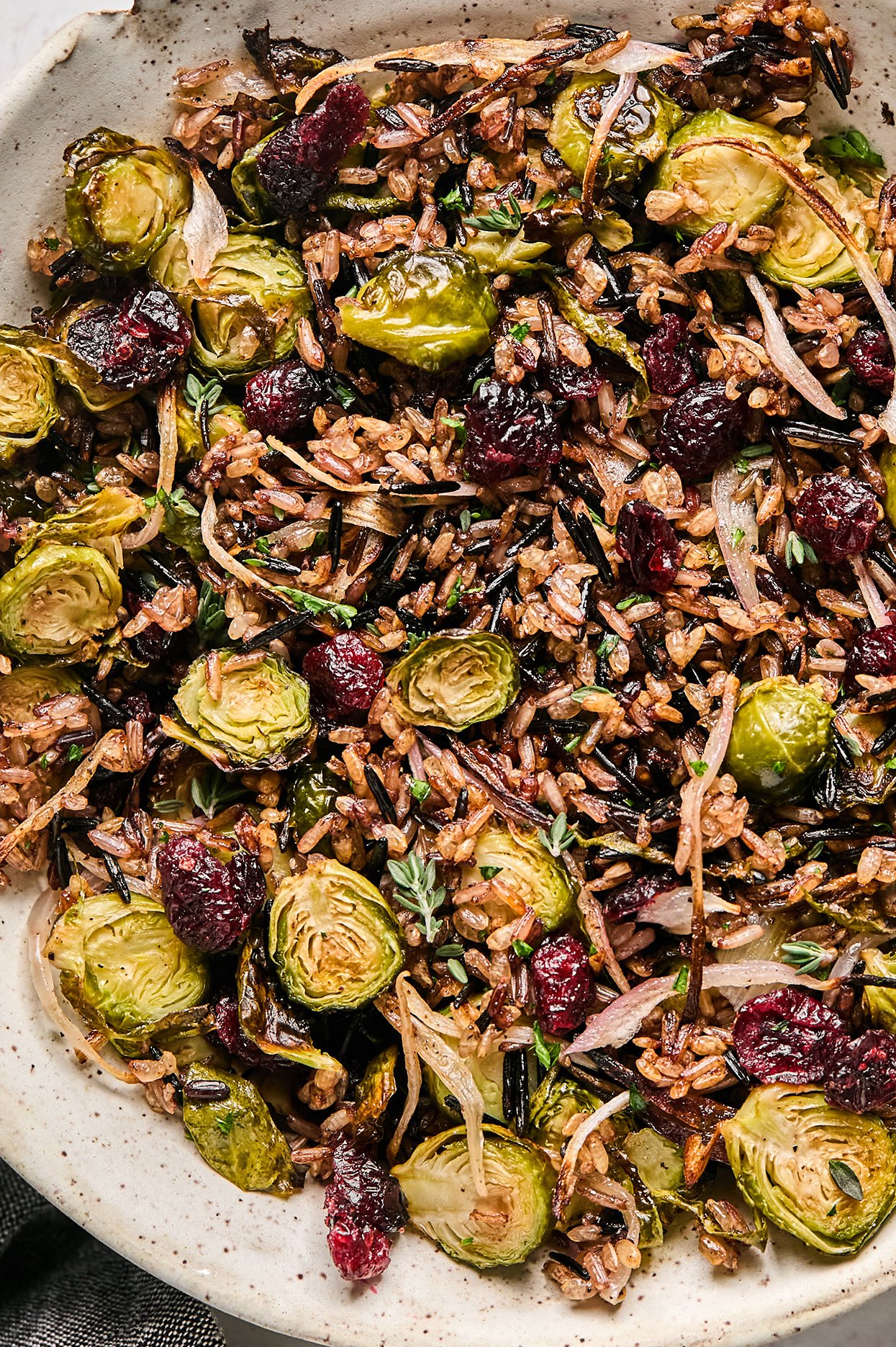 crispy wild rice pilaf with brussels sprouts, shallots, dried cranberries, and herbs.