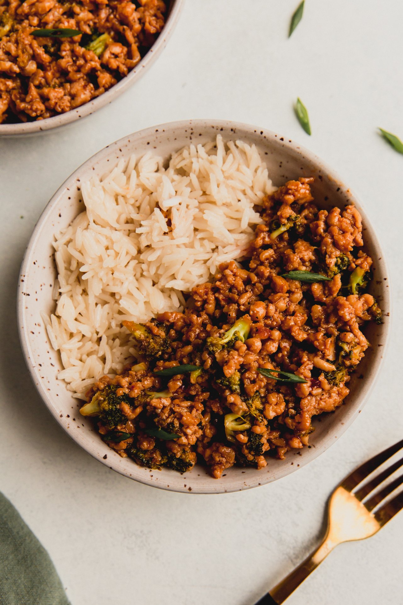 Firecracker ground chicken with broccoli in a bowl paired with rice.