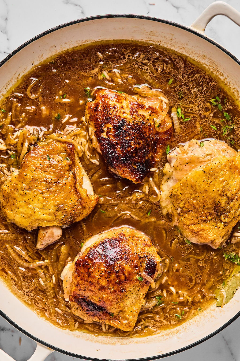 Chicken thighs in the pan before baking.