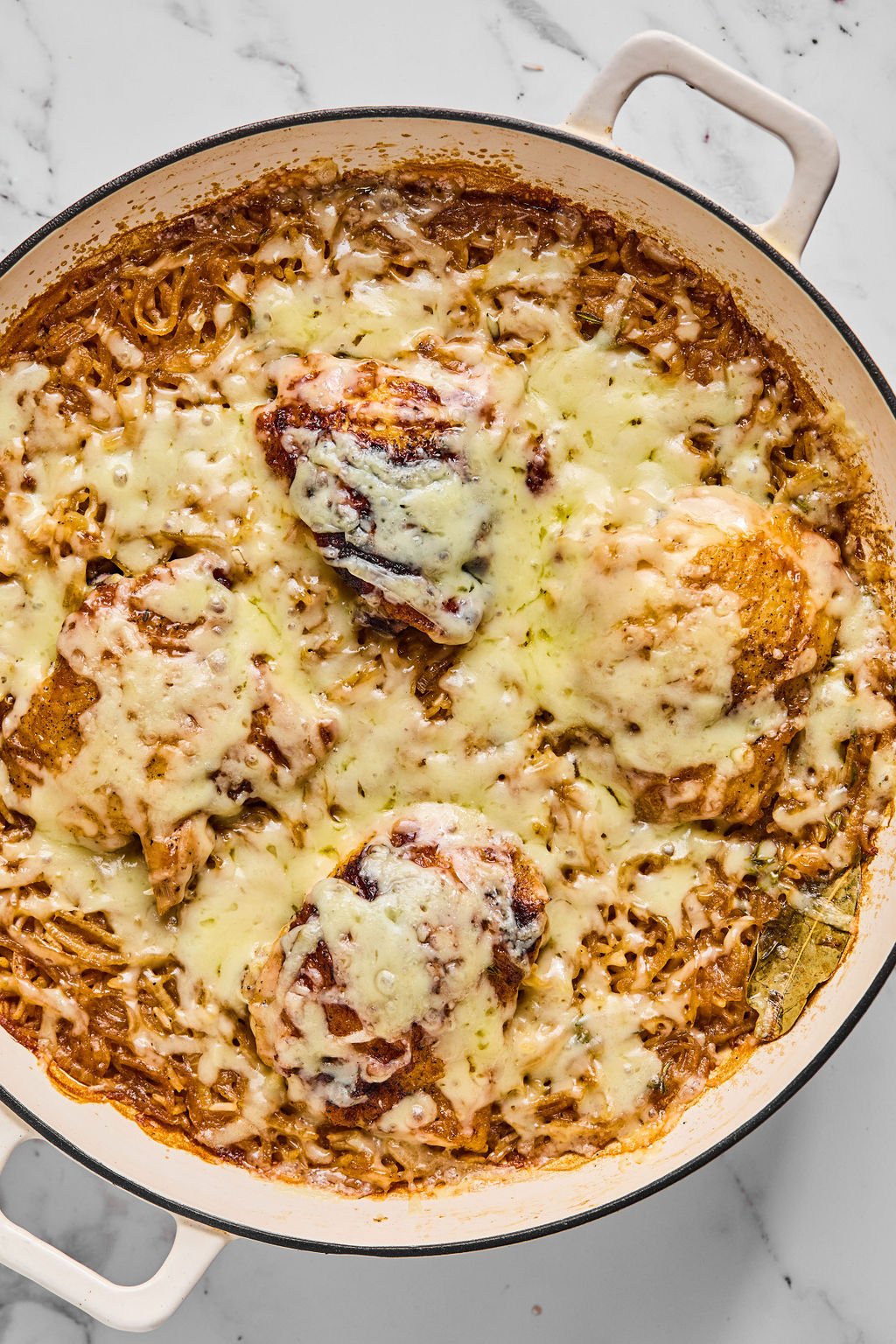 French onion chicken and rice after cooking and being topped with cheese, ready to be enjoyed.