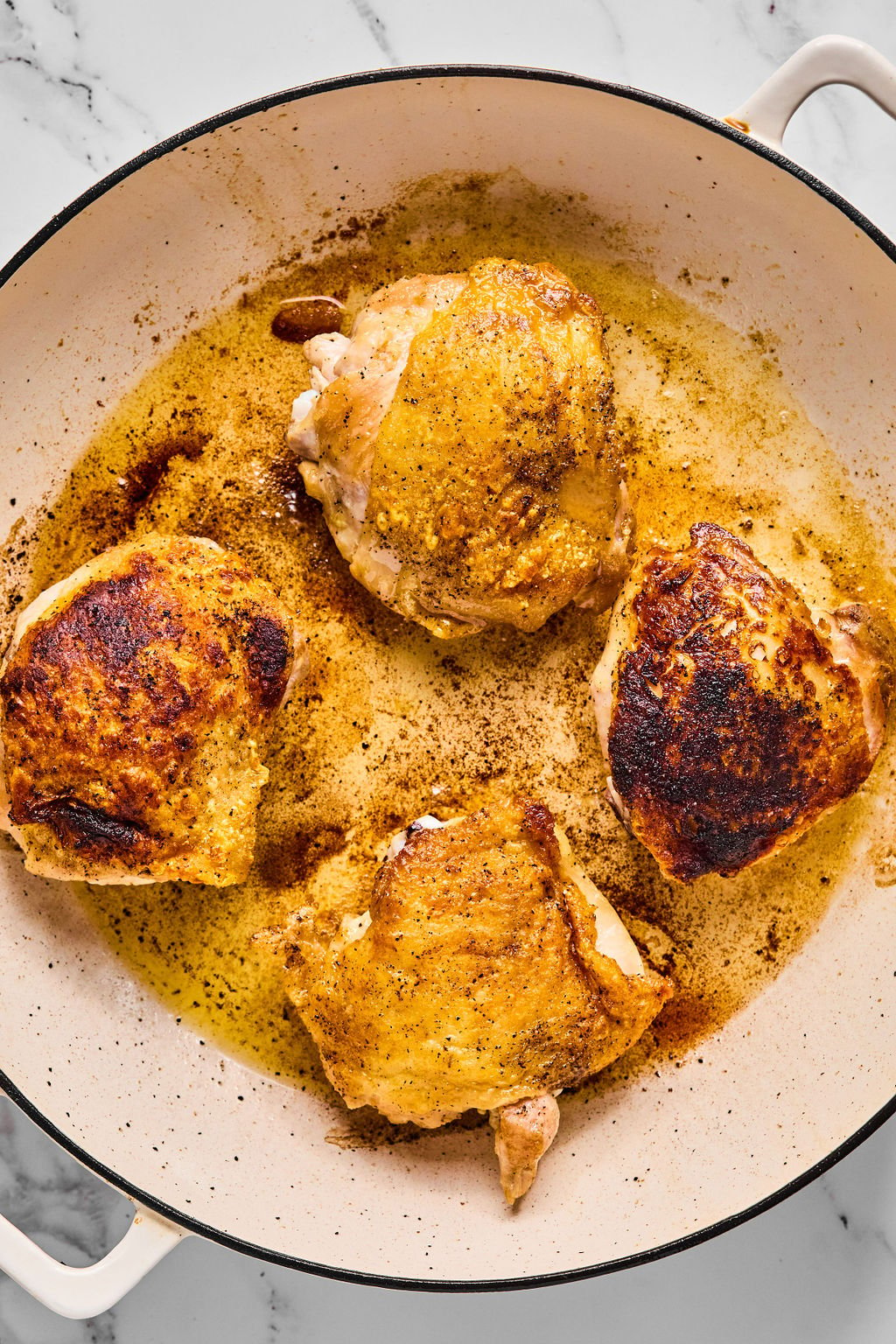 Chicken thighs after crisping in the pan.