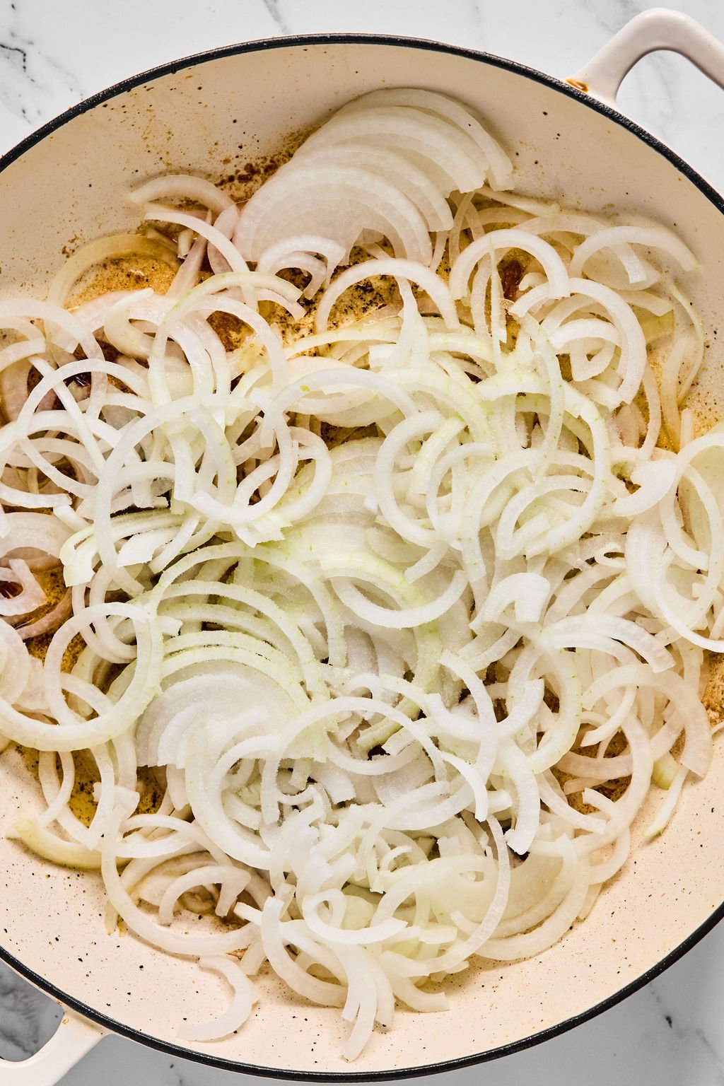 Onions in the pan before sauting.