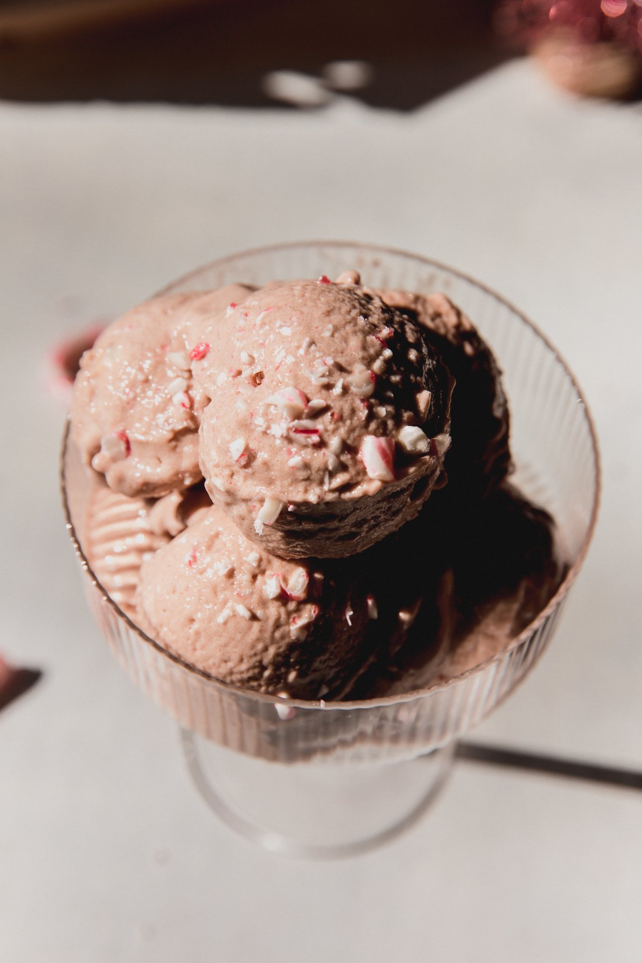 A scoop of pepperpint protein ninja creami ice cream in a glass bowl.