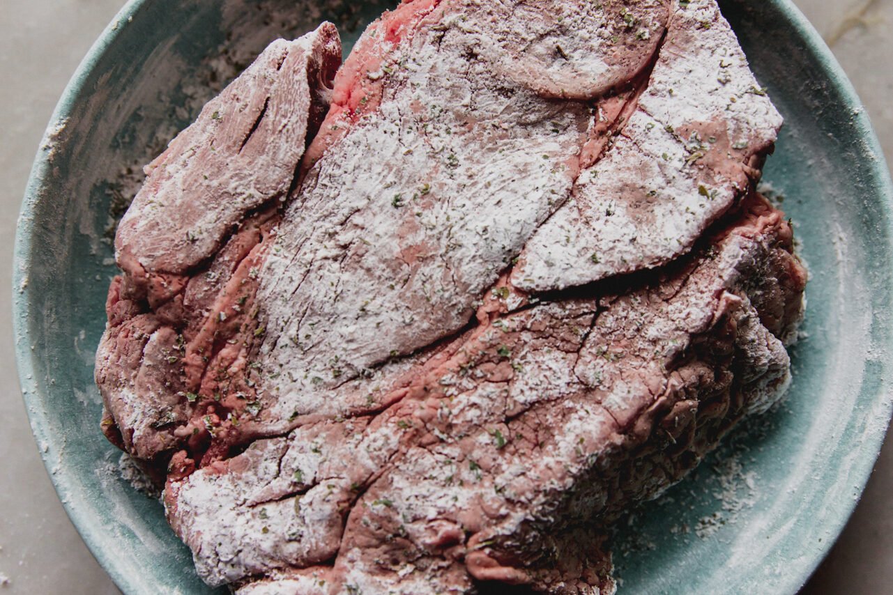 The meat covered in arrowroot starch before cooking.