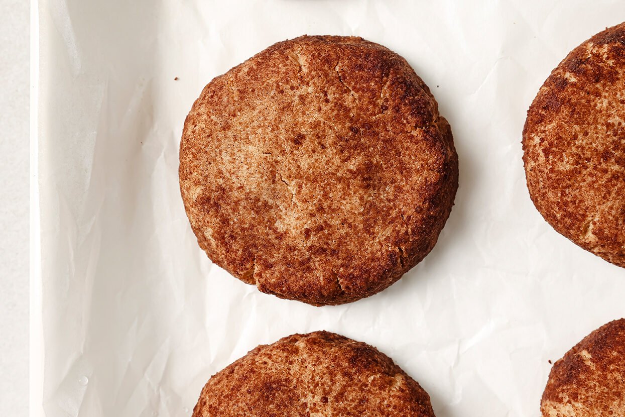 The snickerdoodle cookies after baking still on the baking sheet.