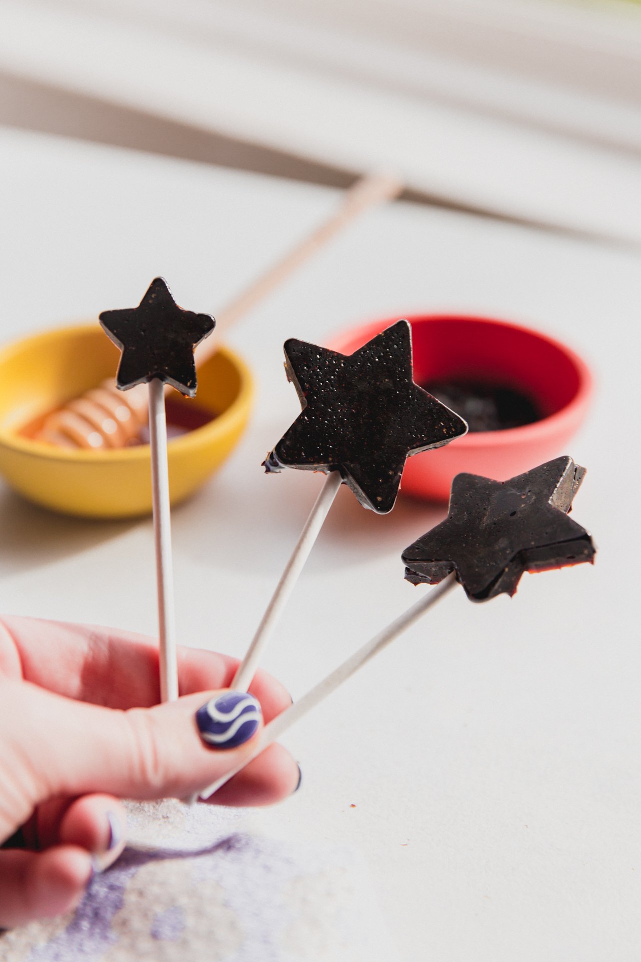 Three star shaped elderberry lollipops. 