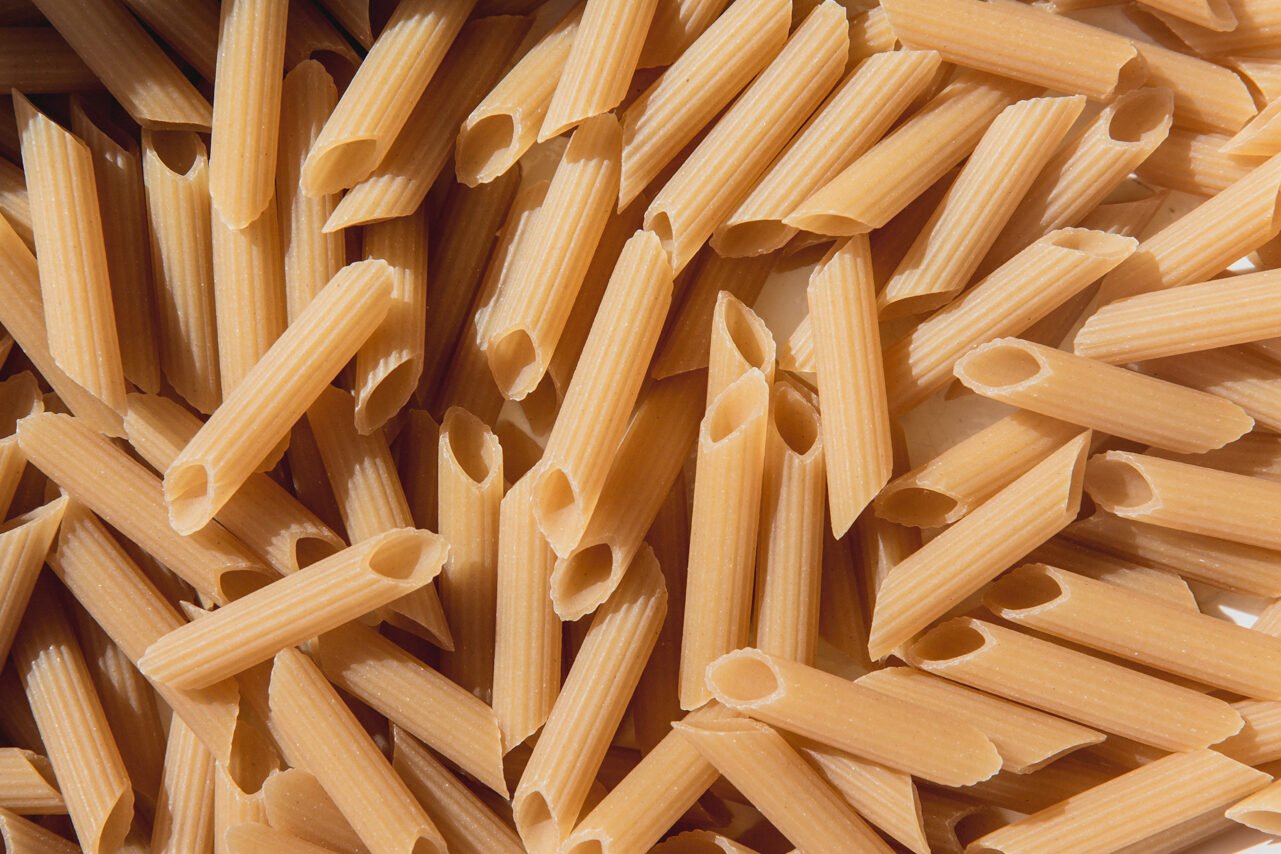Uncooked pasta in a baking dish.