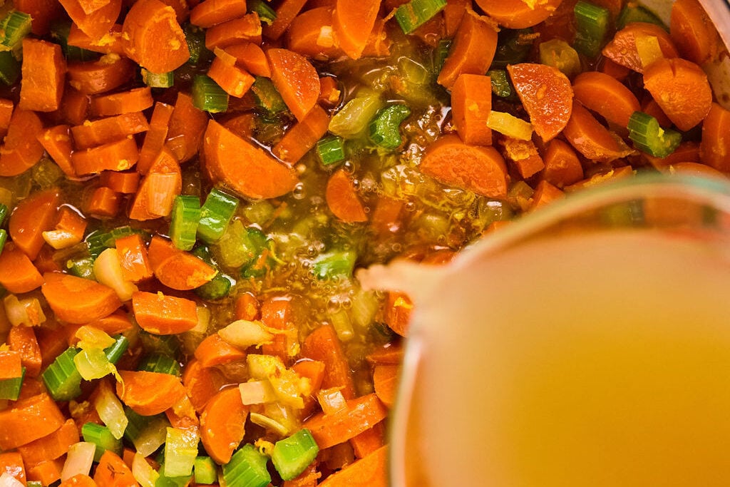 Pouring the broth into the soup.