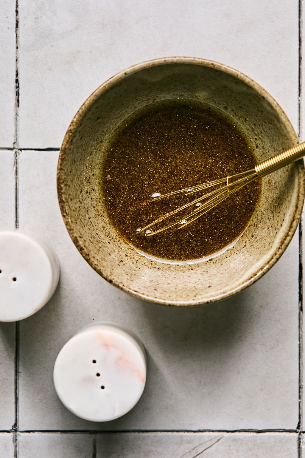 avocado oil, coconut aminos, apple cider vinegar, and spices, combined in a bowl