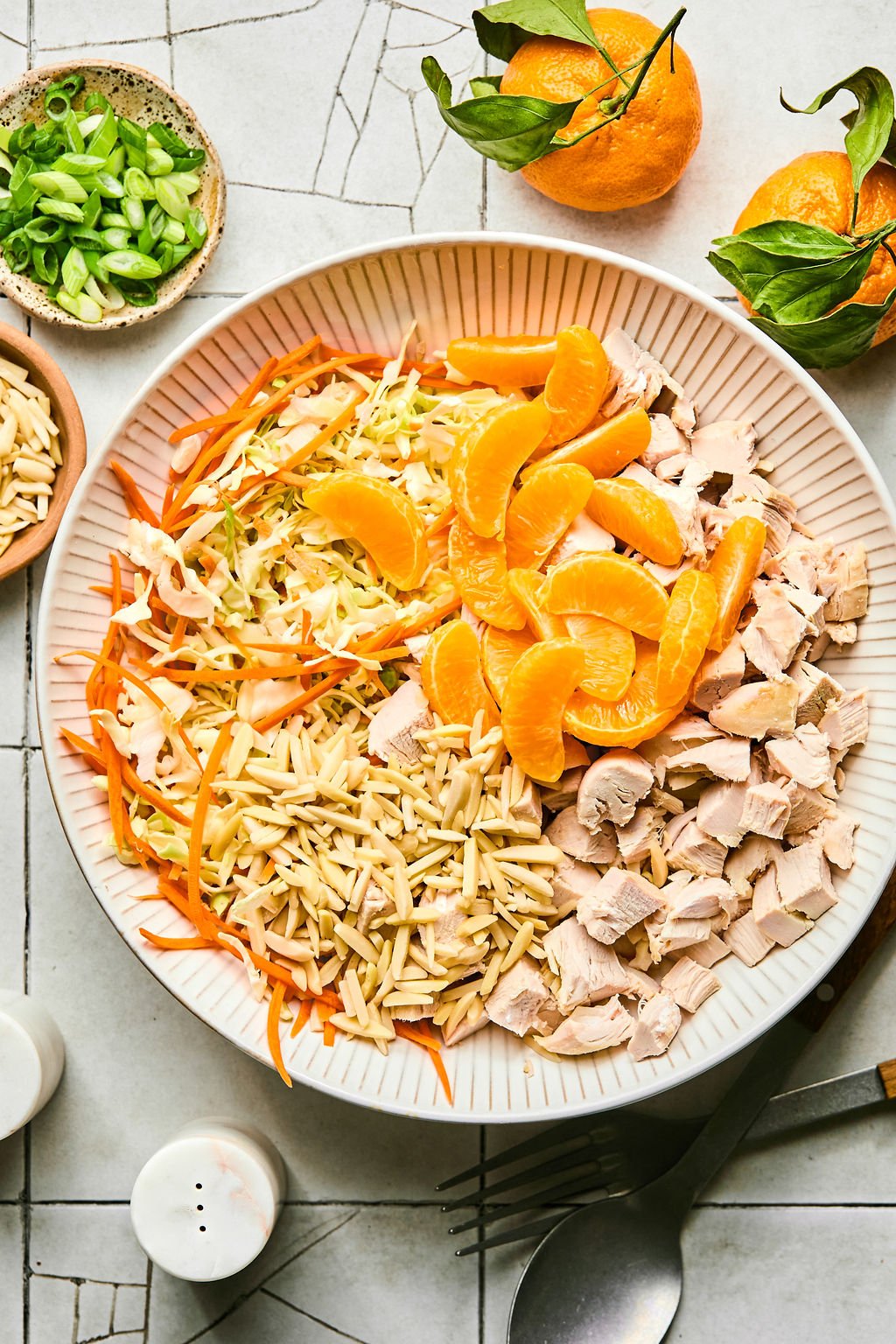 coleslaw mix, chicken, shredded carrots, almond, and mandarin, combined in a bowl
