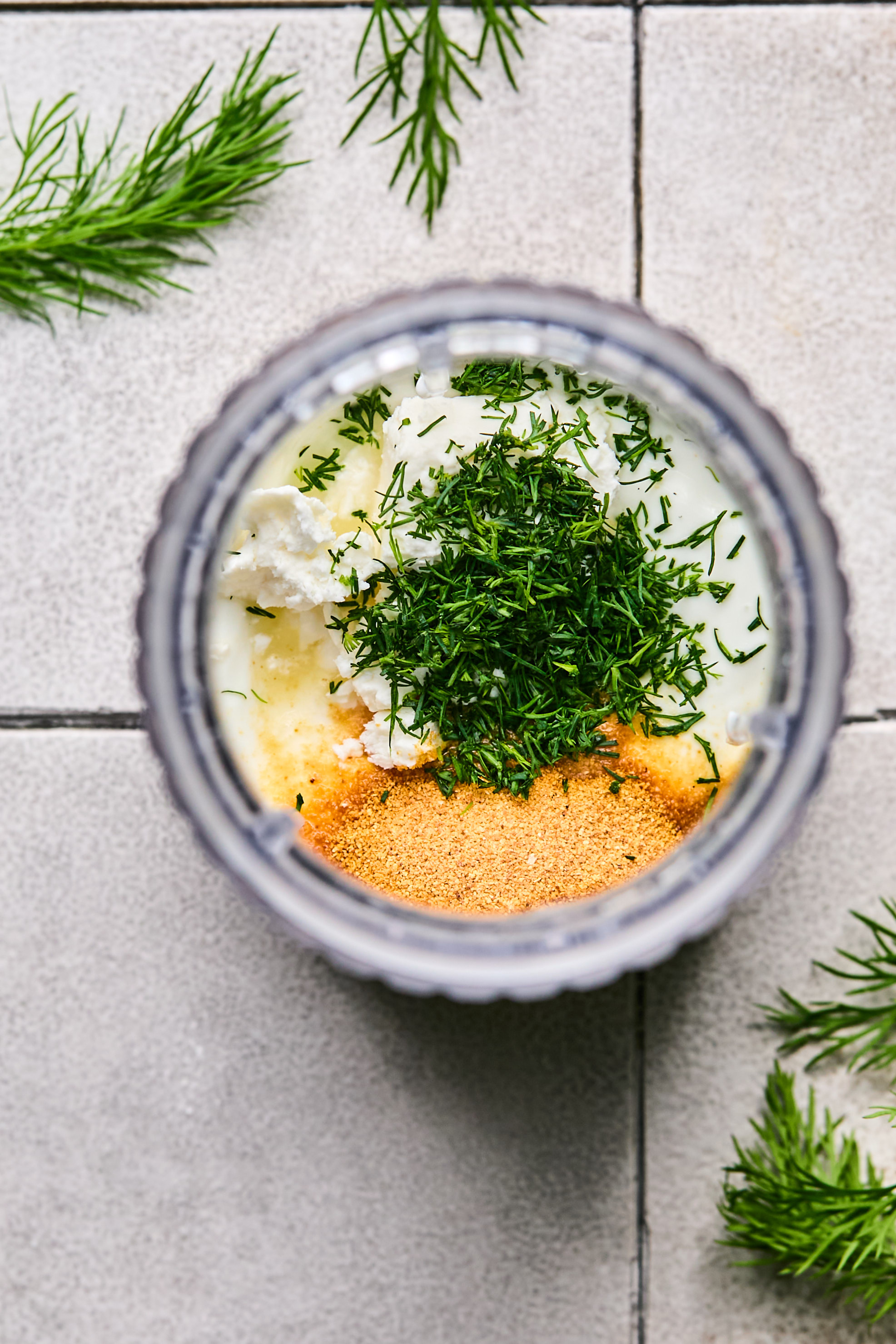 all ingredients for yogurt sauce in a tall mixing cup