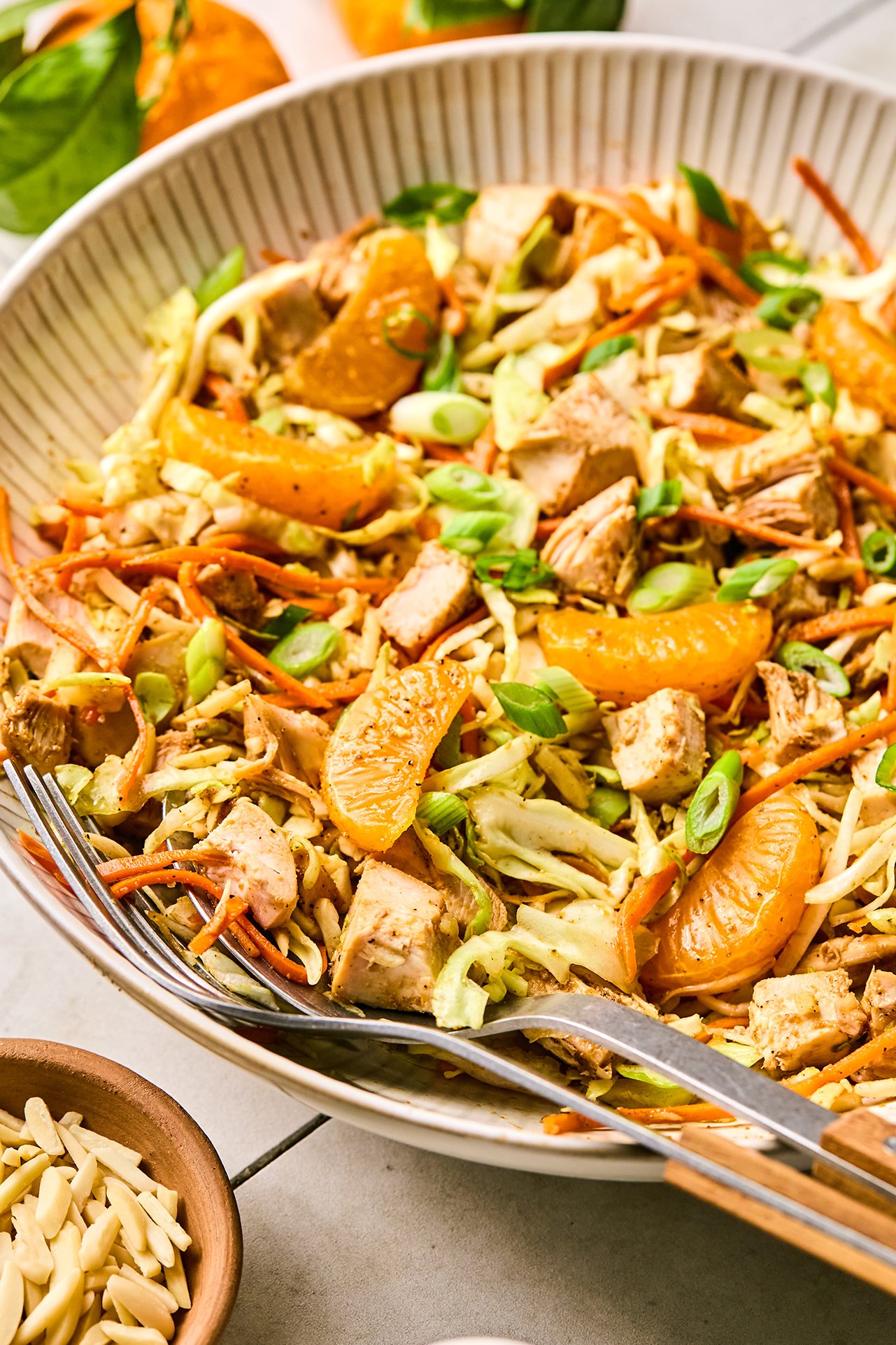 chinese chicken salad in a bowl, topped with green onion