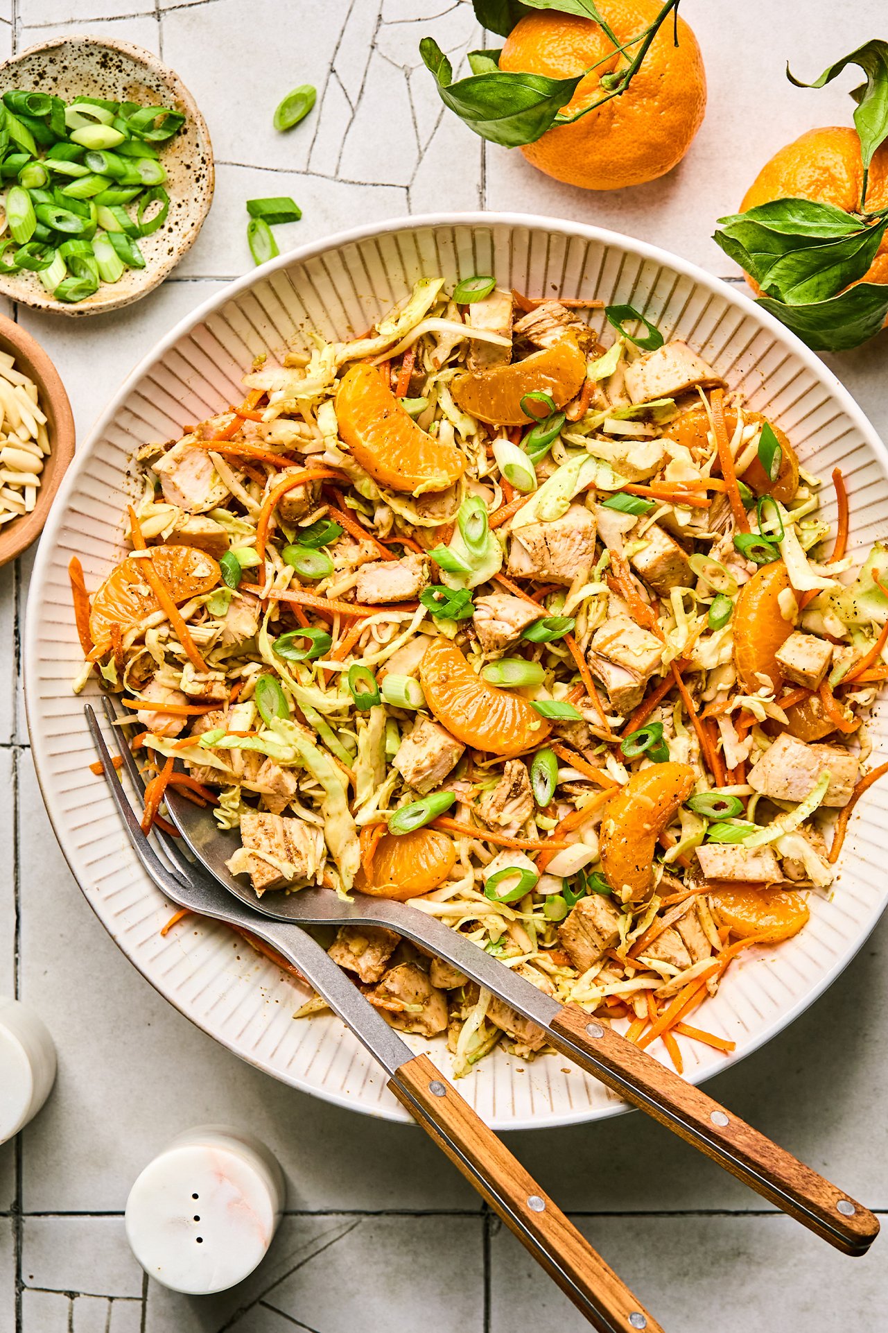 chinese chicken salad in a bowl, topped with green onion