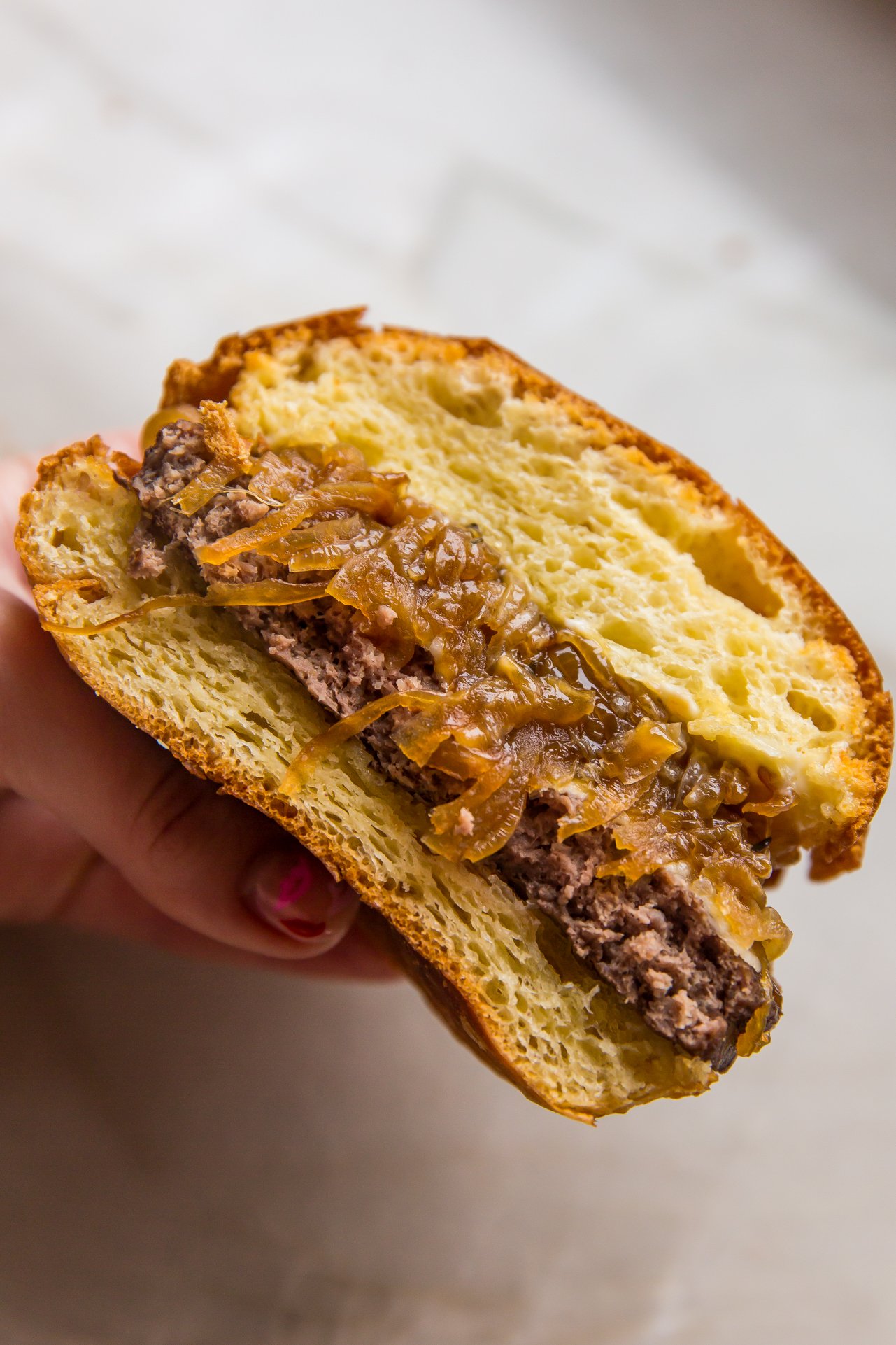 French onion burger sliced in half. 