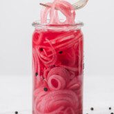 Apple cider vinegar pickled onions in a jar with a fork.