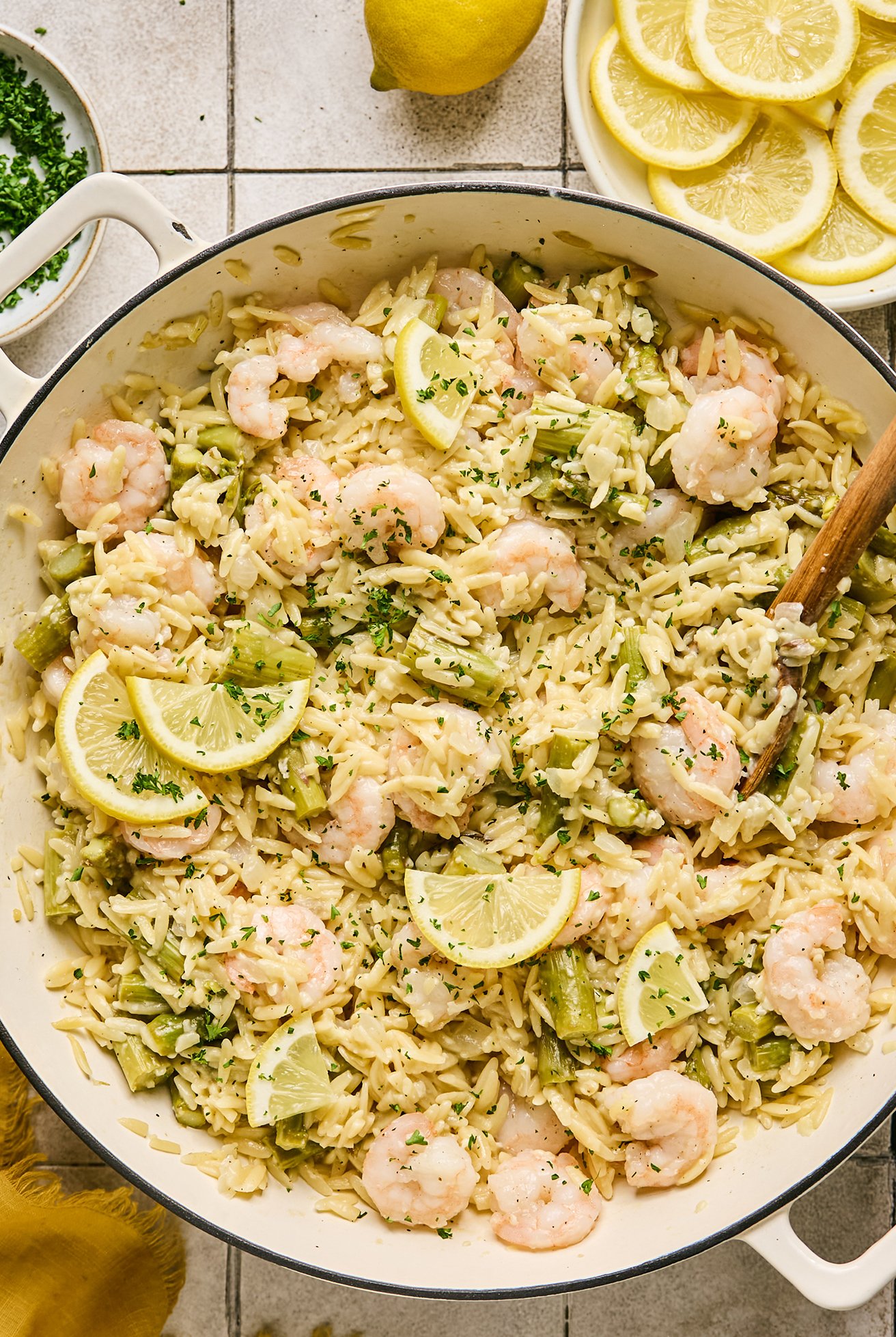 gluten free lemon shrimp and orzo, in a pot with a serving spoon