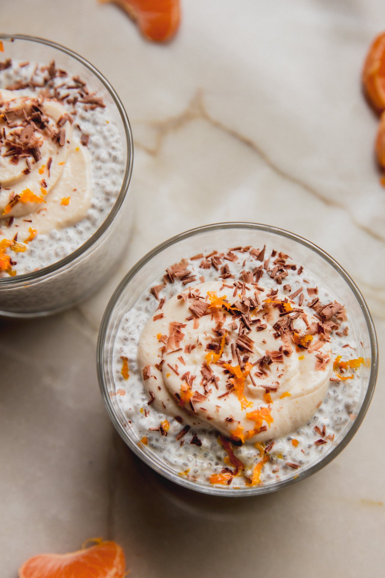 Two cups of cannoli chia seed pudding on a counter.