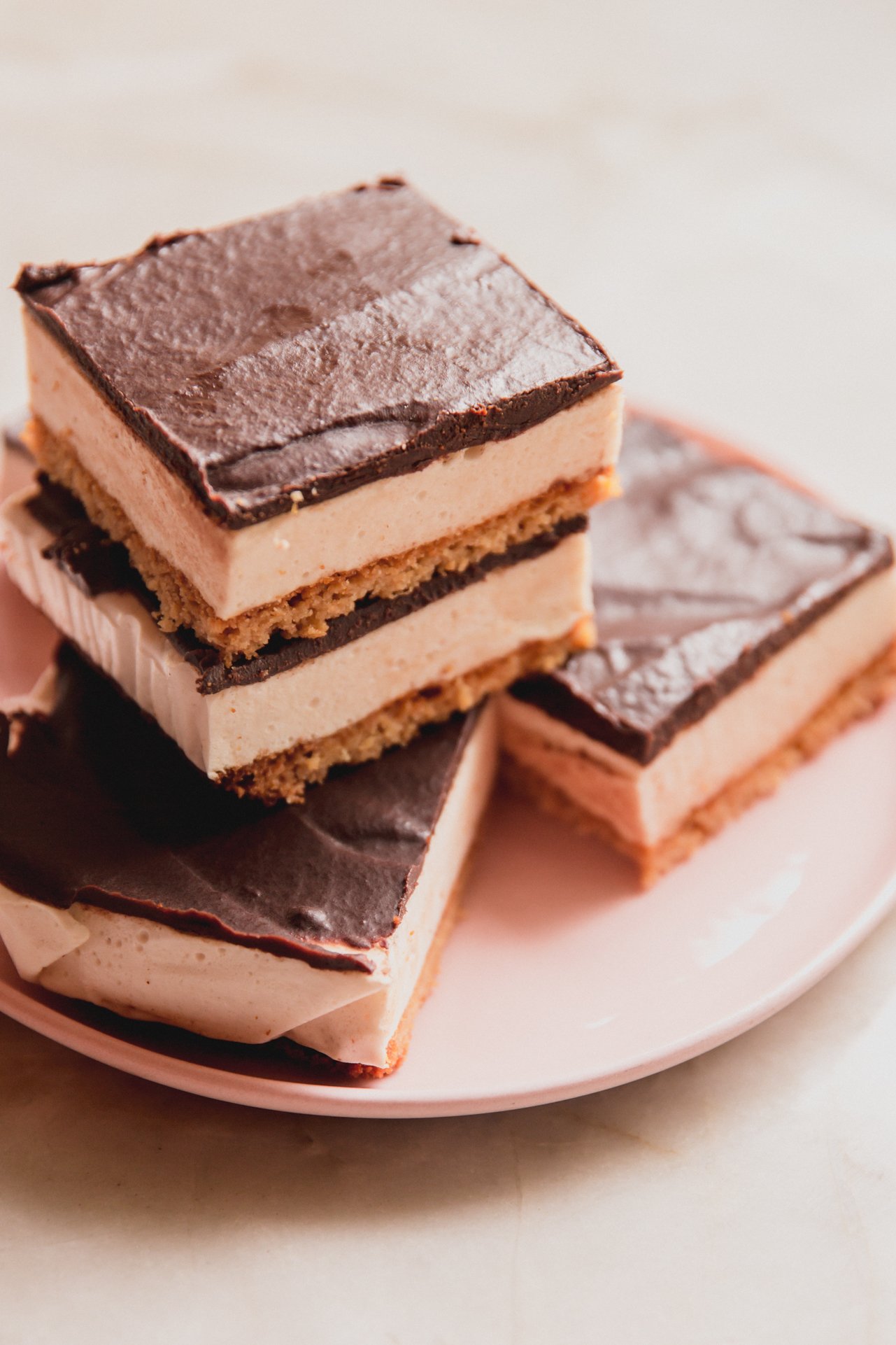S'mores protein bars stacked on a plate.