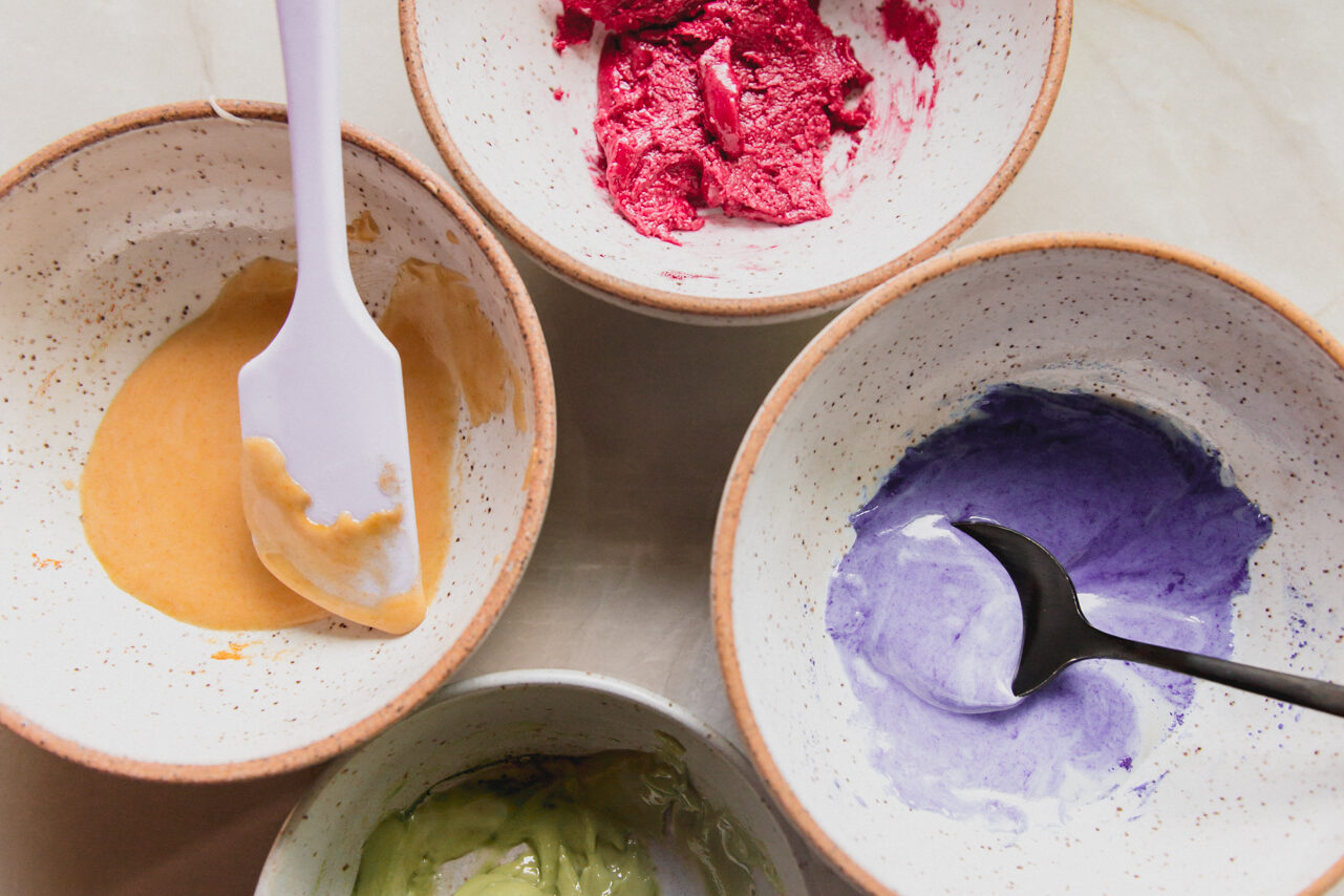 Four bowls each with dyed paste to make sprinkles.