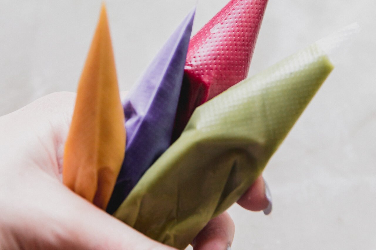 Four tubes filled with the dyed paste to make sprinkles.