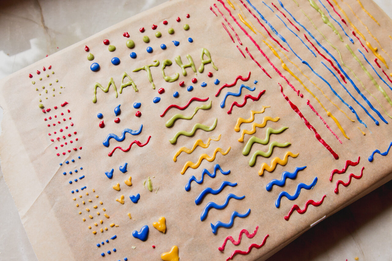 A piece of parchment paper covered in paste that will dry to make sprinkles.