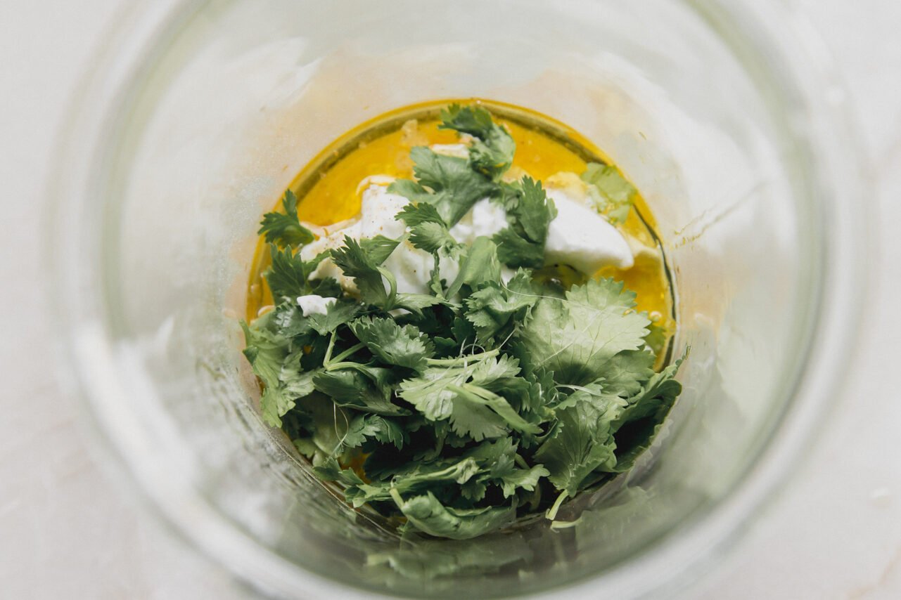 All the ingredients for homemade taco salad dressing in a glass jar before blending.