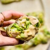 Caesar rice paper roll cut in half with some dressing.