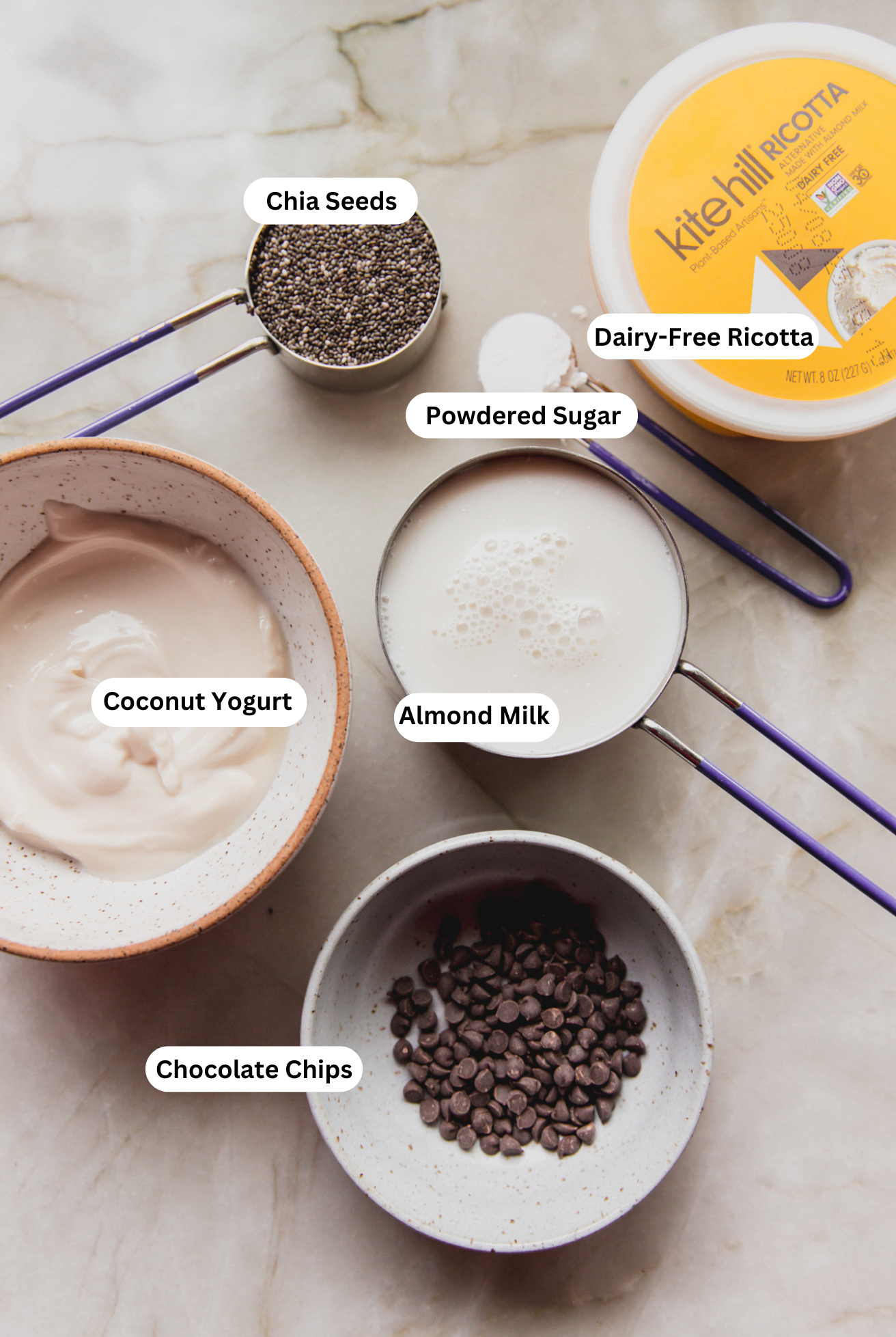 All of the ingredients to make cannoli chia seed pudding ready on a counter.