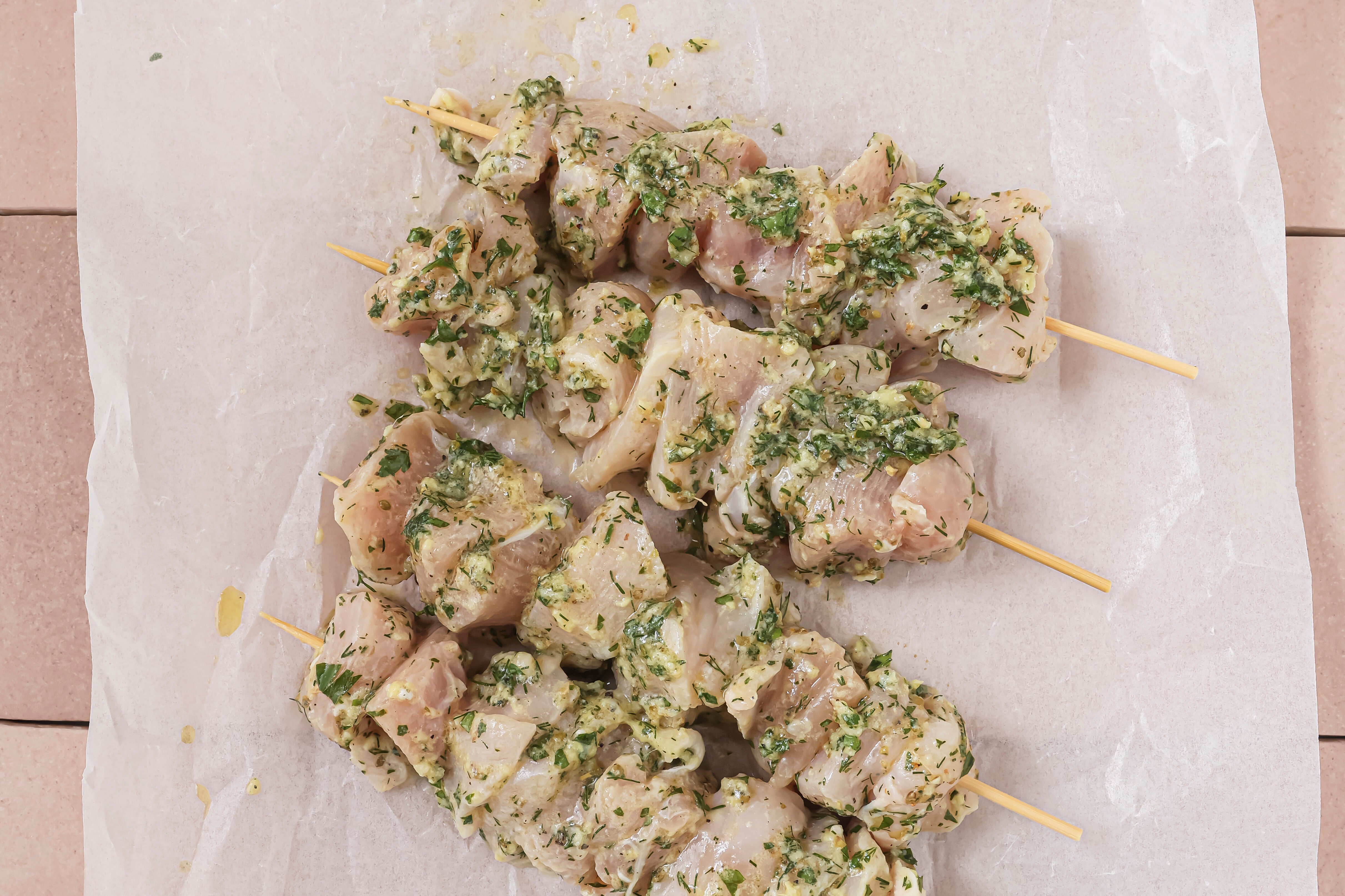Raw chicken souvlaki on skewers.