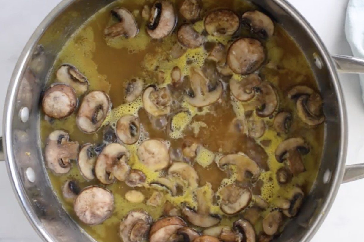 Chicken marsala sauce in a pan.