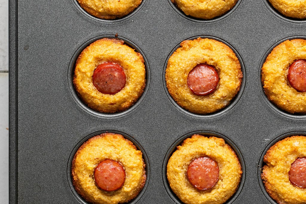 Corn dog muffins baked in a muffin tin.