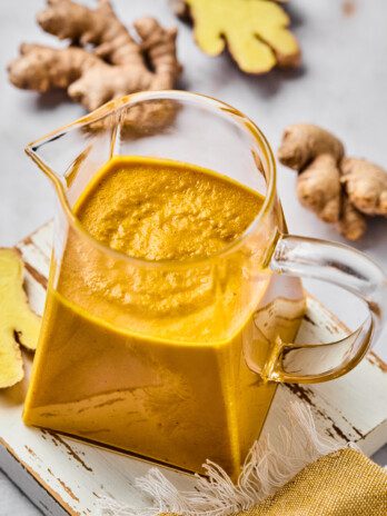 Japanese ginger dressing in a pitcher with fresh ginger on the side.