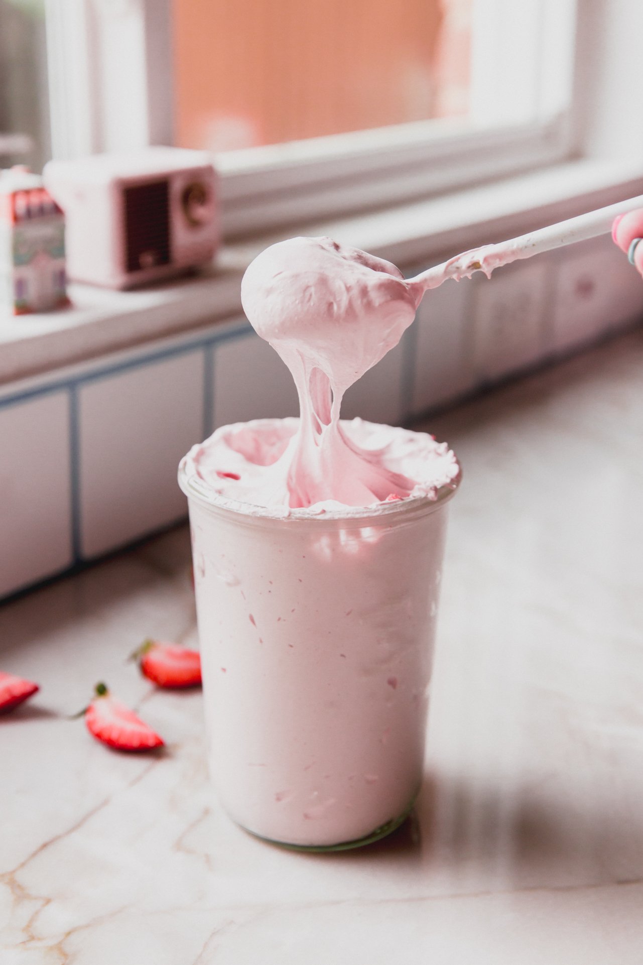 Marshmallow strawberry fluff with a spoon.