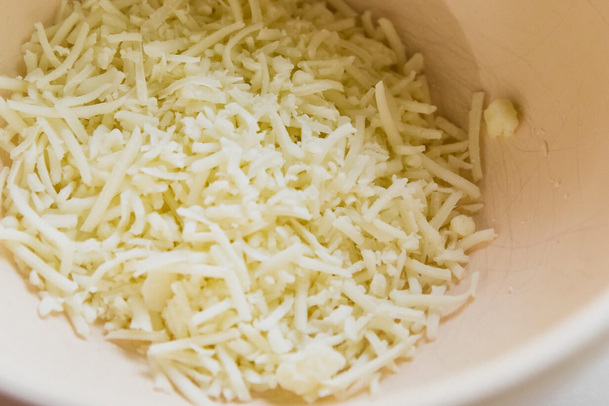 Shredded cheese in a bowl.