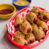 Gluten free pigs in a blanket in a basket.