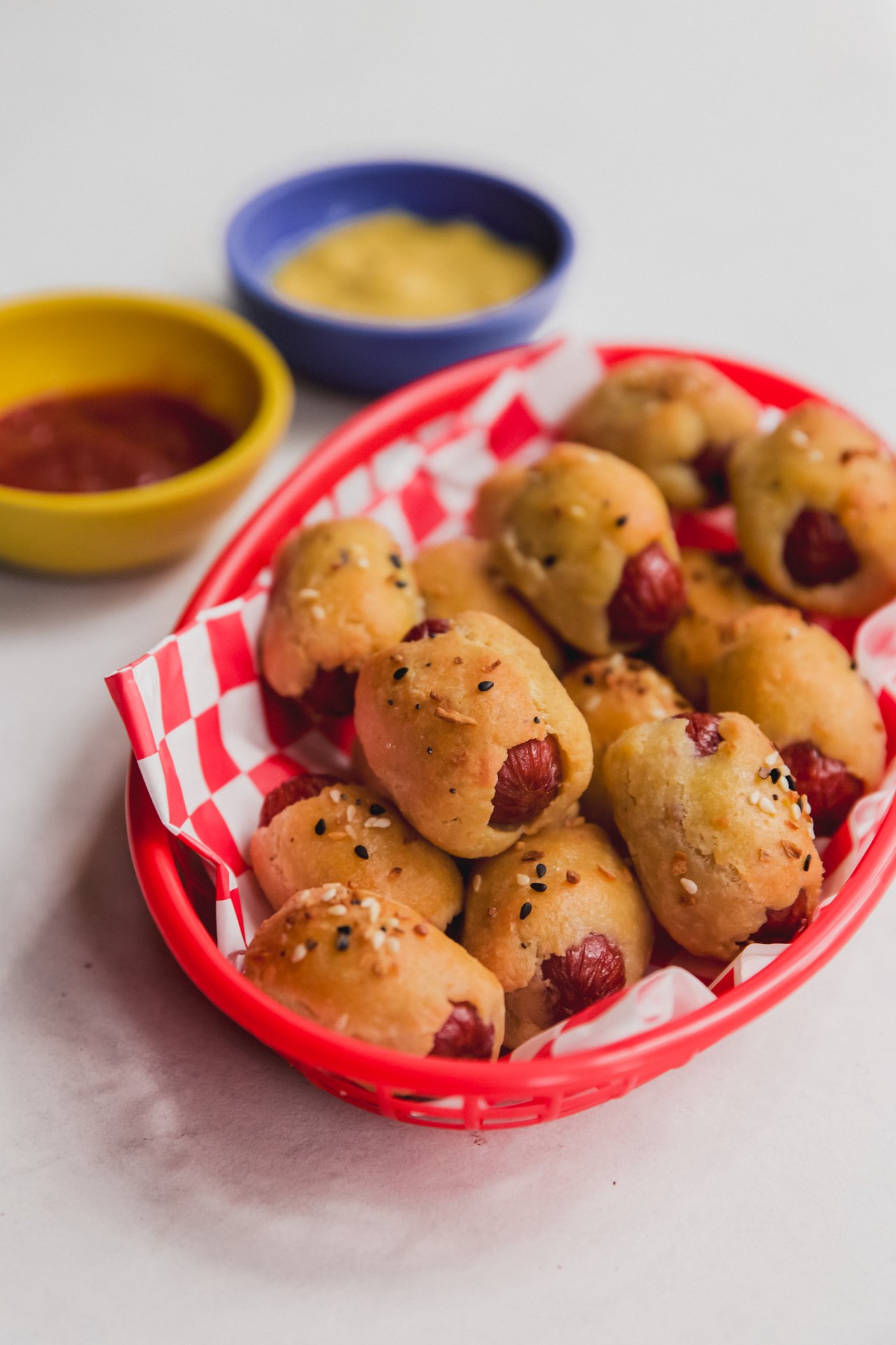 Gluten free pigs in a blanket in a basket.