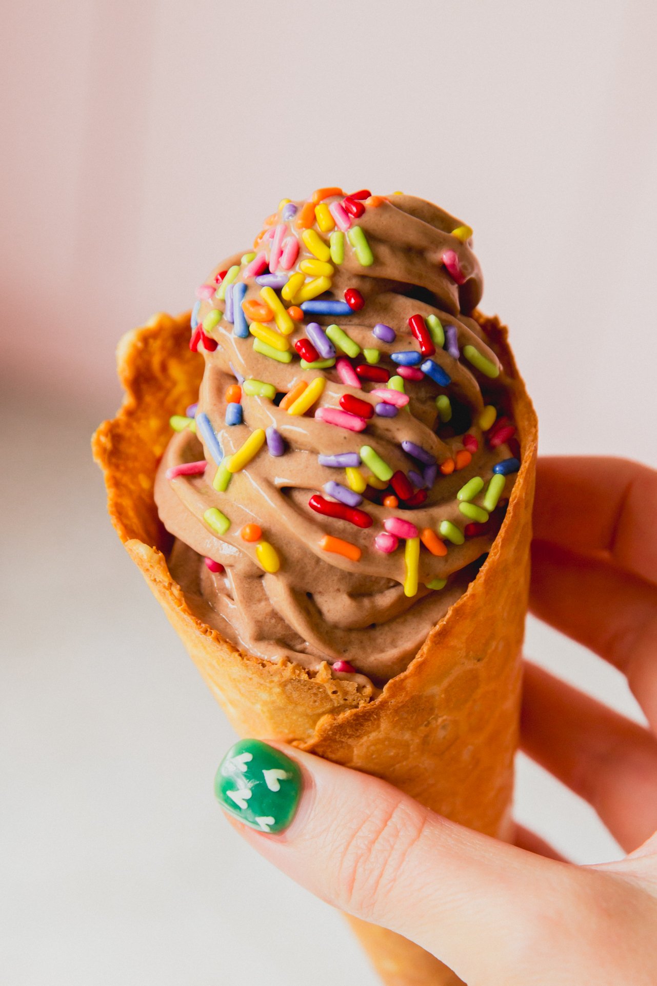 Dairy Free Ninja creami protein ice cream in a cone topped with sprinkles.
