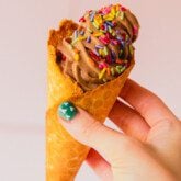 Chocolate protein ice cream in a cone.