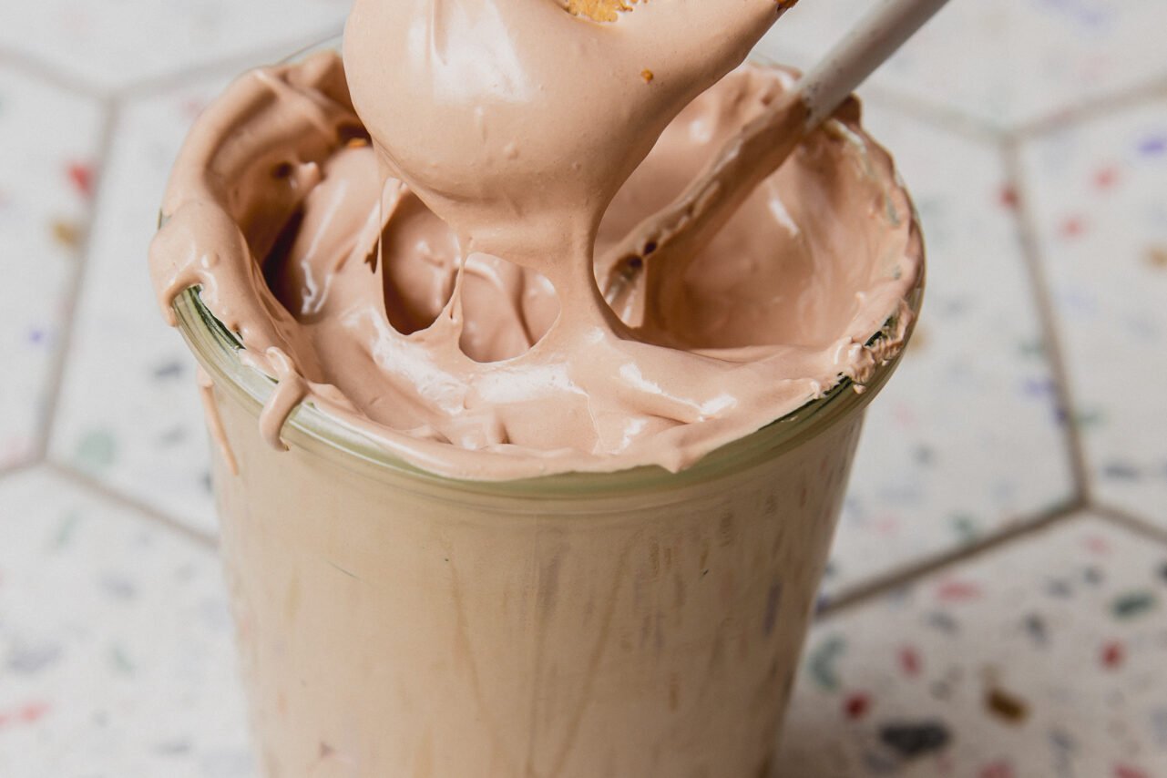 A spoon taking a bite of chocolate espresso marshmallow fluff out.