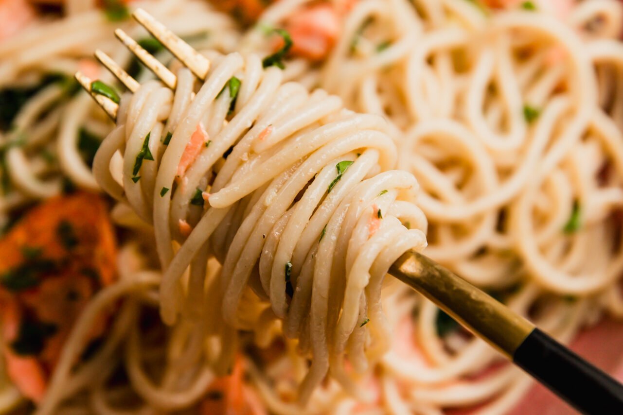 Lemon salmon pasta with a fork twirling the pasta.