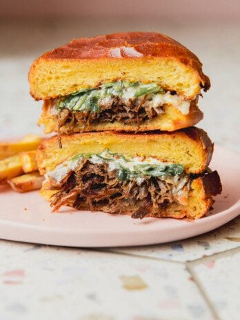 Pot roast sandwich sliced in half and stacked.