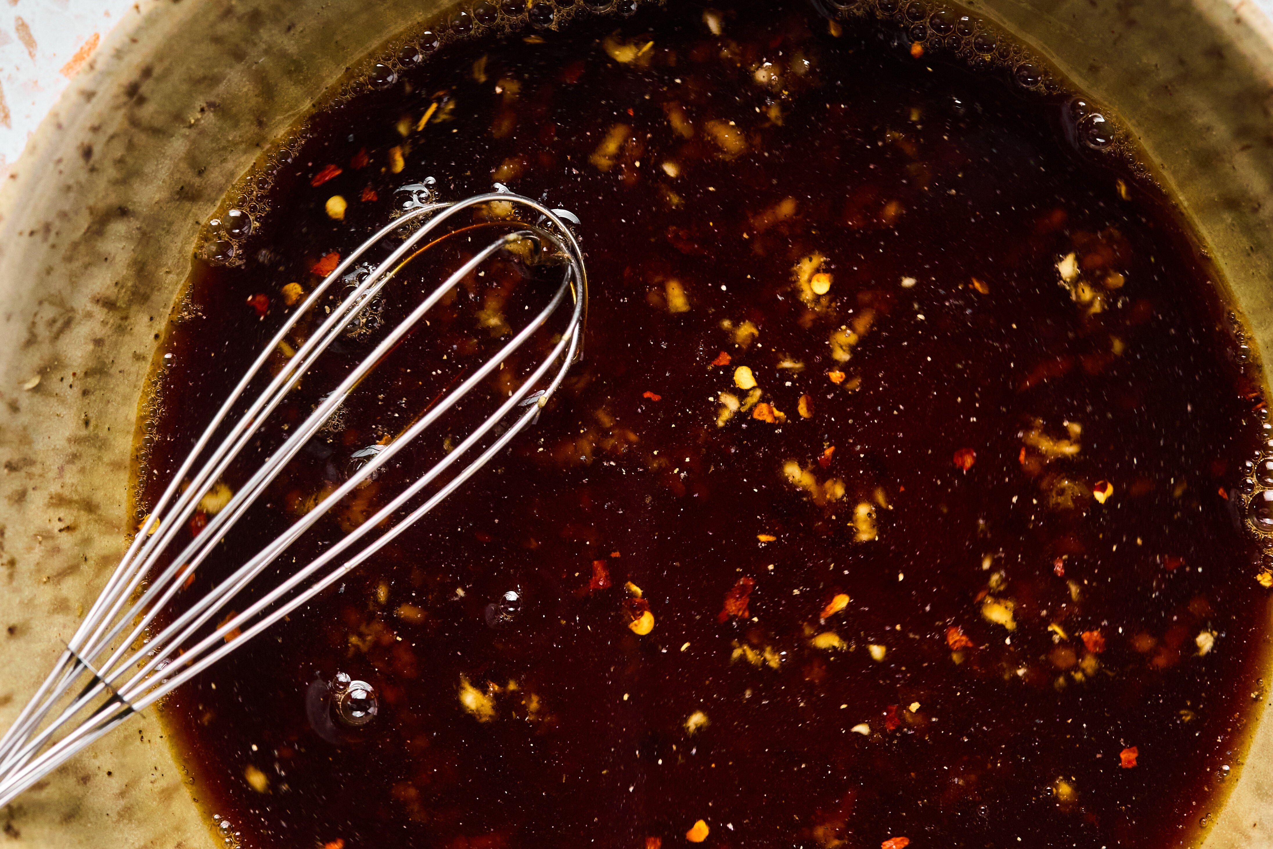 A bowl of marinate after being whisked together.
