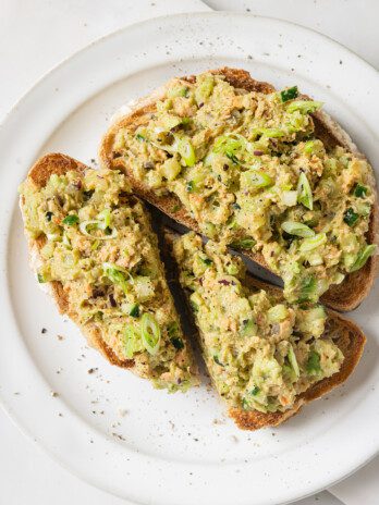 Avocado salmon salad on two slices of toast.