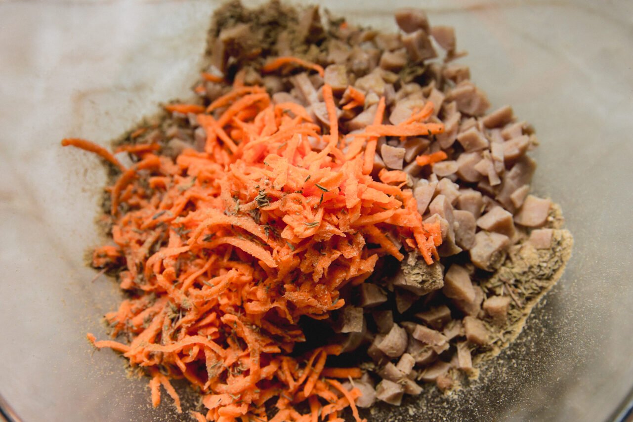 The sausage and shredded sweet potato in a bowl before mixing.