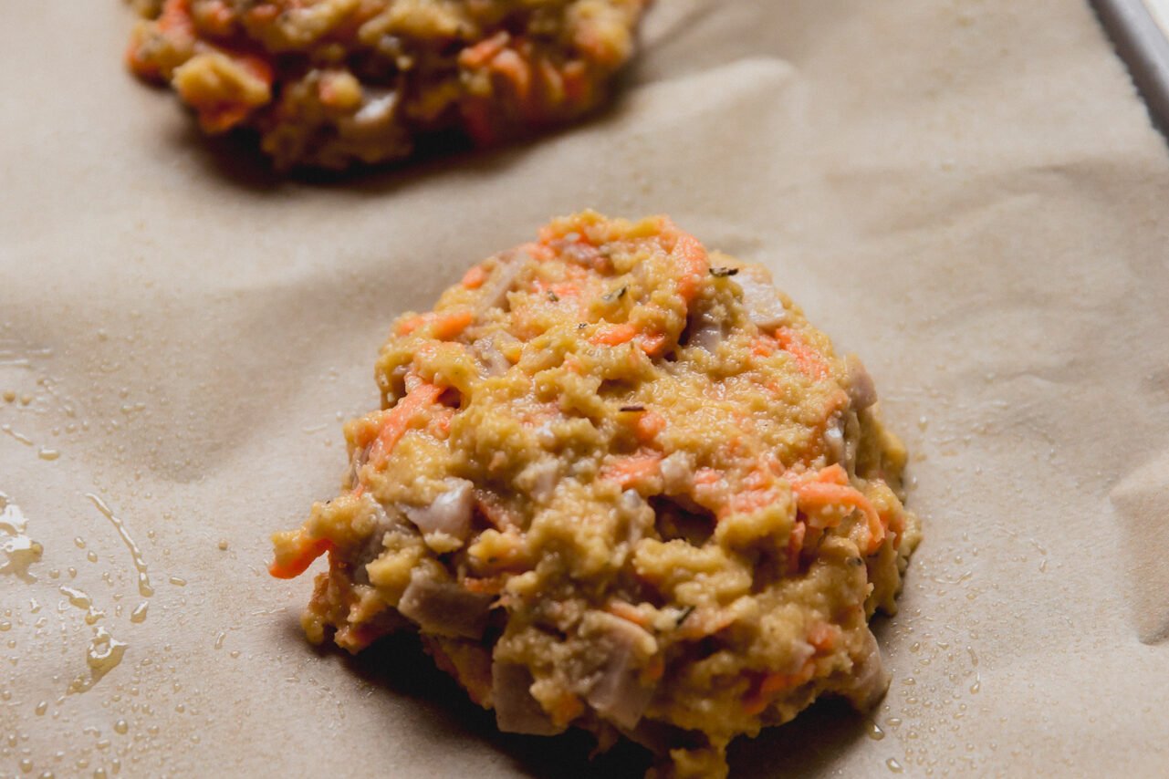 The dough for protein breakfast biscuits scooped out on a baking sheet.