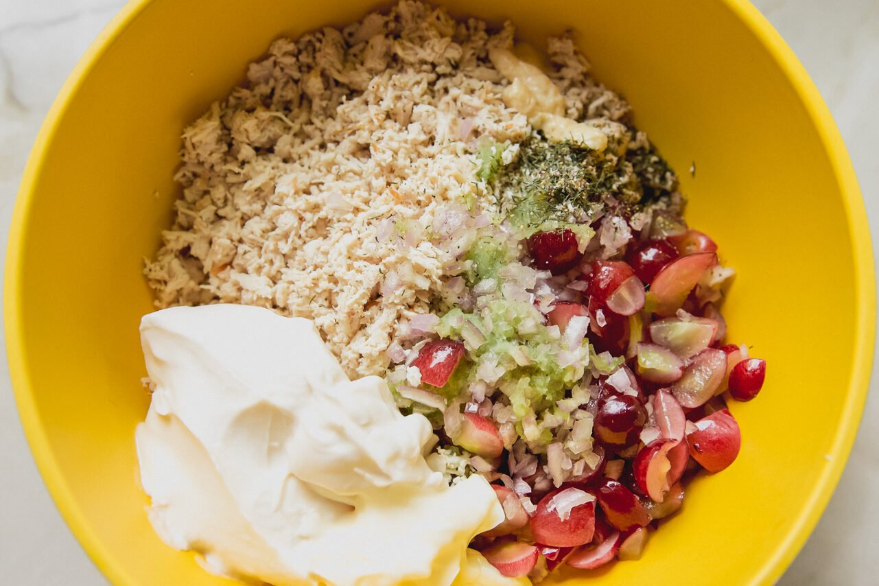 All the ingredients for the chicken salad in a bowl before mixing.