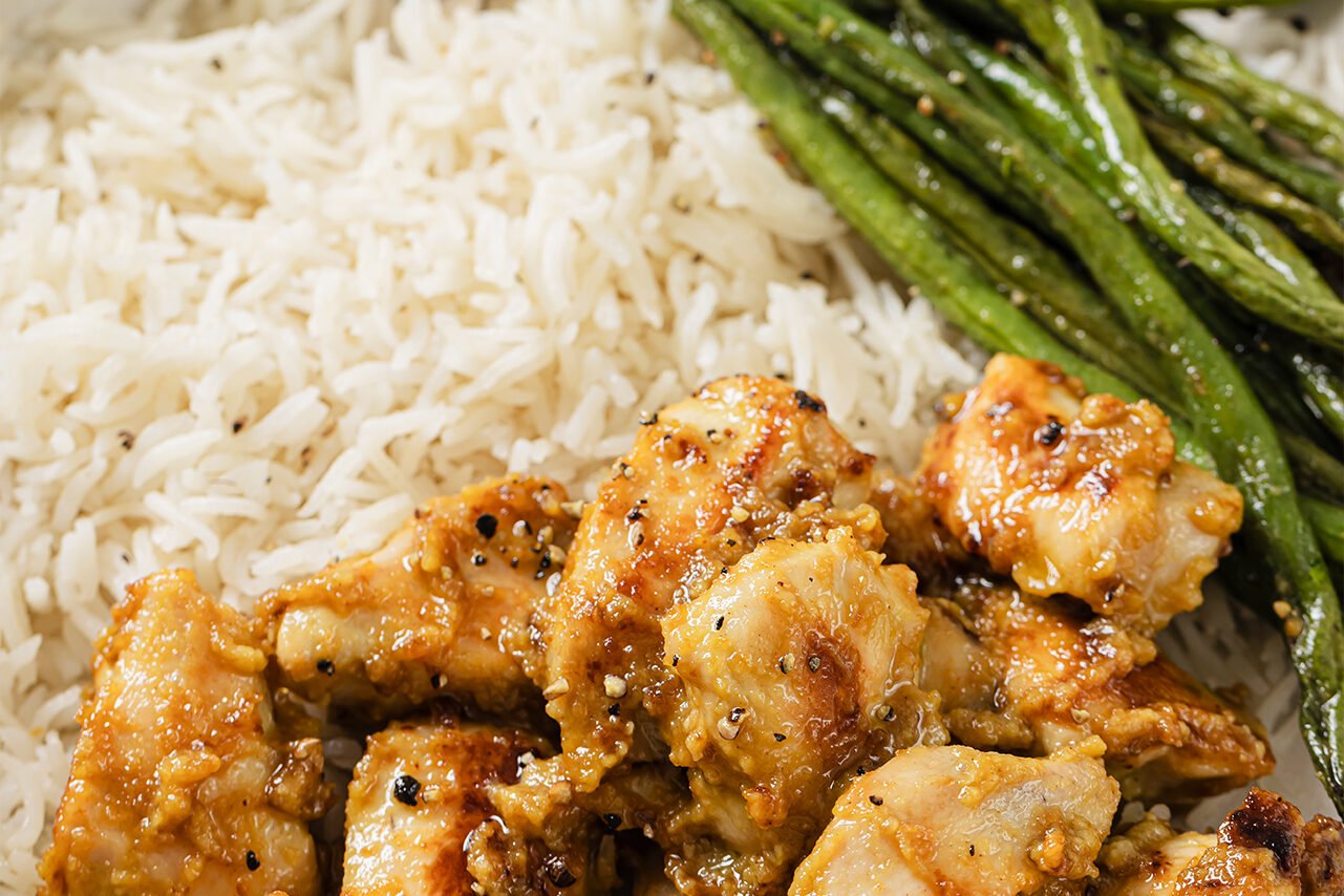 Honey mustard chicken bowls with a side of rice and green beans.