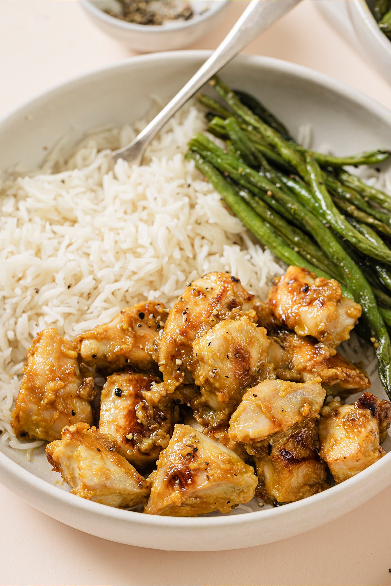 Honey mustard chicken bowls with a side of rice and green beans.