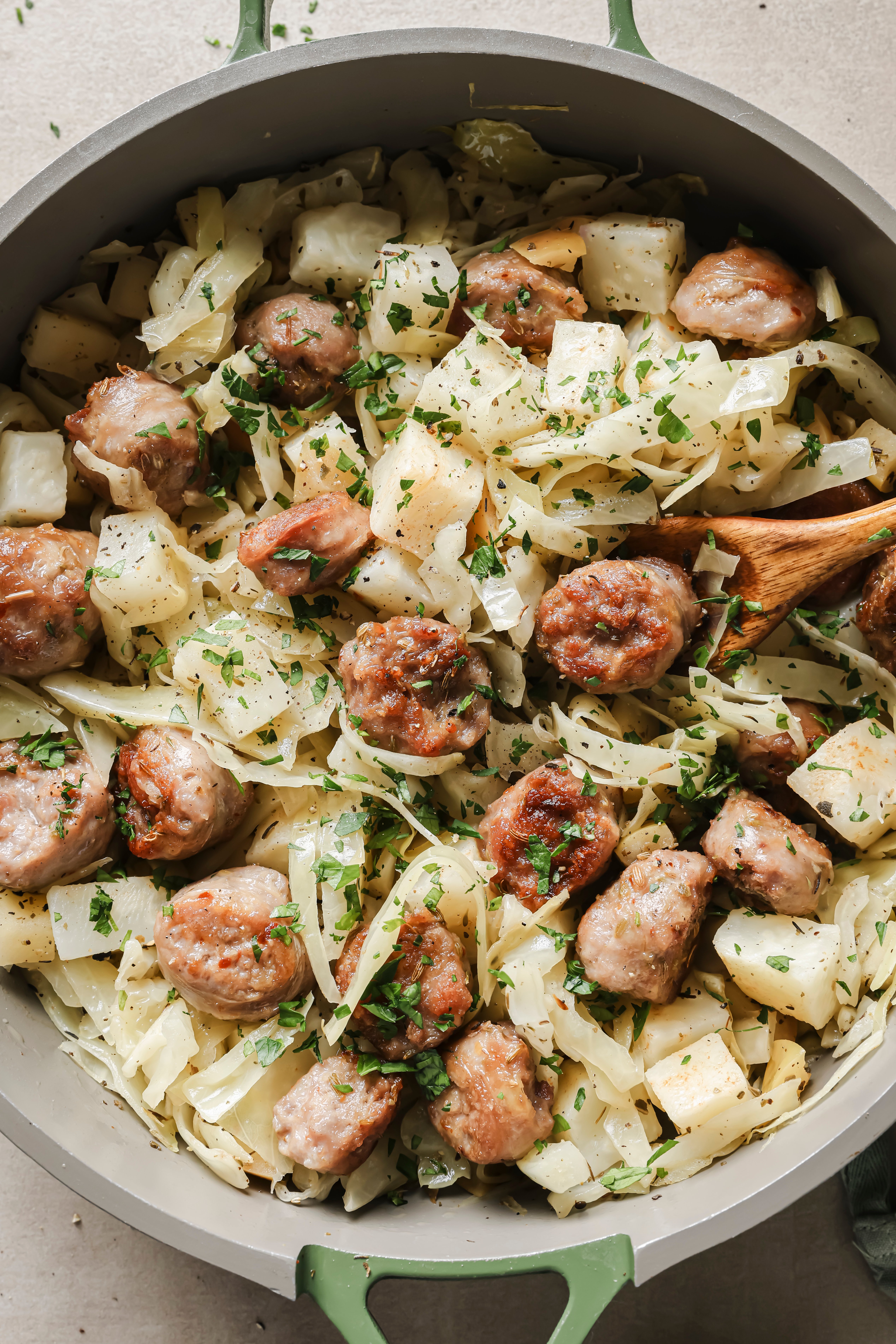 A pan with cabbage and sausage breakfast skillet in it.